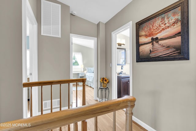 33 Fleetwood Dr, Hazlet, NJ 07730 - hallway featuring lofted ceiling, an upstairs landing, light wood-type flooring, baseboards, and a sink