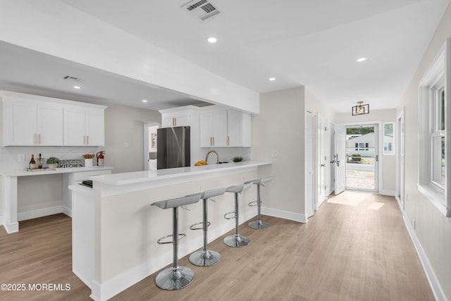 882 Radio Rd, Little Egg Harbor, NJ 08087 - kitchen featuring freestanding refrigerator, light wood finished floors, white cabinetry, light countertops, and recessed lighting