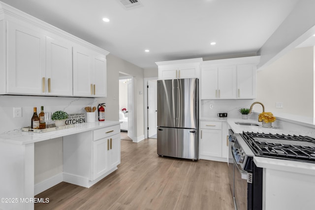 882 Radio Rd, Little Egg Harbor, NJ 08087 - kitchen featuring appliances with stainless steel finishes, a sink, light wood-style floors, recessed lighting, and white cabinetry
