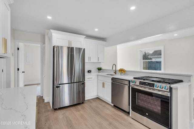 882 Radio Rd, Little Egg Harbor, NJ 08087 - kitchen featuring stainless steel appliances, a sink, white cabinetry, light wood finished floors, and recessed lighting