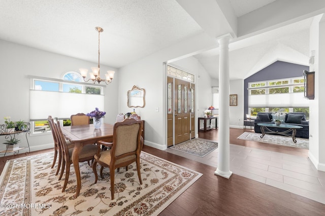 24 Birmingham Ln, Monroe, NJ 08831 - dining room featuring decorative columns, plenty of natural light, a chandelier, lofted ceiling, and wood finished floors