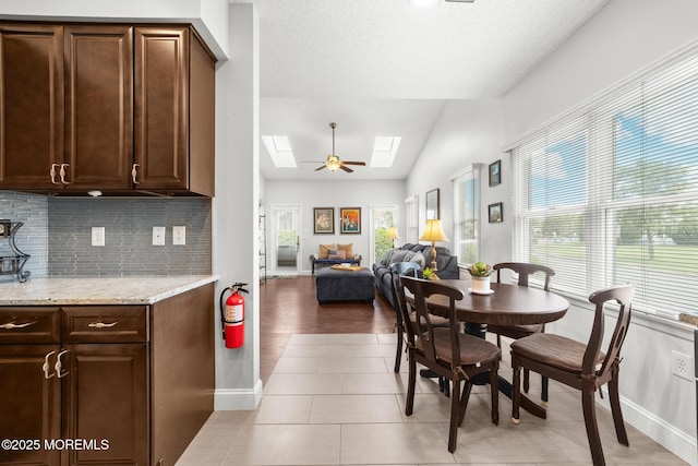 24 Birmingham Ln, Monroe, NJ 08831 - dining area with a skylight, healthy amount of natural light, vaulted ceiling, baseboards, and light tile patterned floors