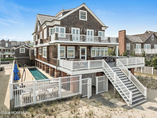 425 E Ave, Bay Head, NJ 08742 - rear view of property with a balcony, an outdoor pool, stairway, and a patio