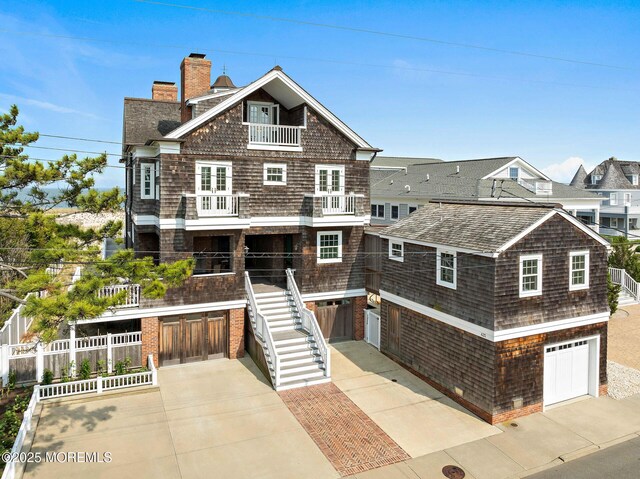 425 E Ave, Bay Head, NJ 08742 - shingle-style home with a garage, a balcony, driveway, a chimney, and stairs