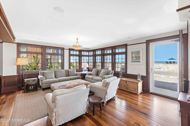 425 E Ave, Bay Head, NJ 08742 - living room with hardwood / wood-style flooring, healthy amount of natural light, wainscoting, and a chandelier