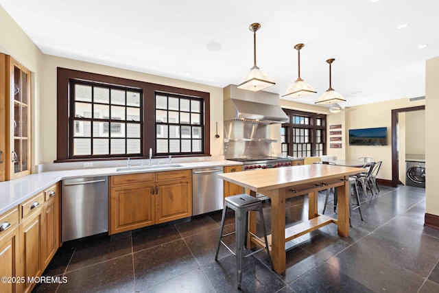 425 E Ave, Bay Head, NJ 08742 - kitchen with stainless steel dishwasher, wall chimney range hood, washer / clothes dryer, decorative light fixtures, and recessed lighting