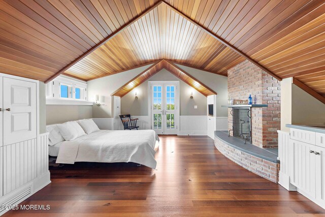 425 E Ave, Bay Head, NJ 08742 - bedroom with vaulted ceiling, a wainscoted wall, french doors, a fireplace, and multiple windows