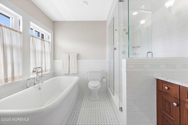 425 E Ave, Bay Head, NJ 08742 - full bath with tile walls, a freestanding bath, a shower stall, wainscoting, and vanity