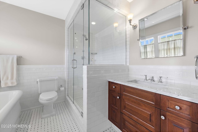 425 E Ave, Bay Head, NJ 08742 - bathroom with tile walls, wainscoting, vanity, a stall shower, and a freestanding bath