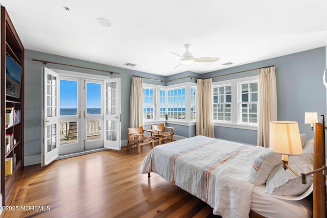 425 E Ave, Bay Head, NJ 08742 - bedroom featuring access to outside, wood finished floors, french doors, a water view, and ceiling fan
