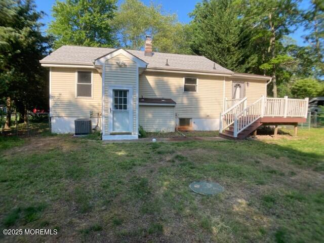 273 Stuart St, Howell, NJ 07731 - back of house featuring a deck, a lawn, a chimney, and central AC unit