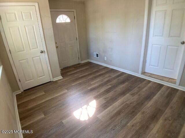 273 Stuart St, Howell, NJ 07731 - entrance foyer with dark wood-type flooring and baseboards