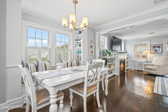 321 Mckinley Pl, Avon-By-The-Sea, NJ 07717 - dining space with a chandelier, dark wood-style flooring, ornamental molding, a warm lit fireplace, and baseboards