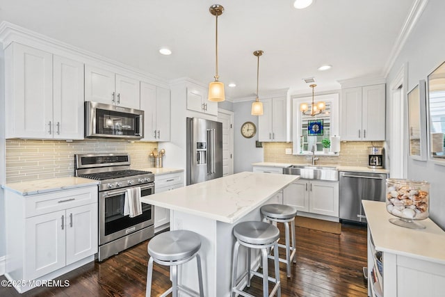 321 Mckinley Pl, Avon-By-The-Sea, NJ 07717 - kitchen featuring stainless steel appliances, a sink, white cabinets, tasteful backsplash, and ornamental molding