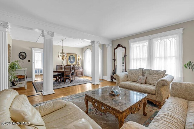 116 Curtis Ave, Manasquan, NJ 08736 - living room featuring decorative columns, wood finished floors, a chandelier, baseboards, and ornamental molding