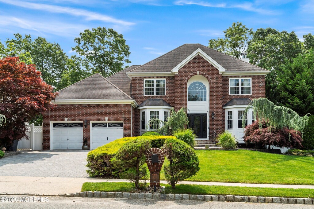 626 Windcrest Ct, Brick, NJ 08724 - view of front of home featuring brick siding, an attached garage, a front yard, decorative driveway, and roof with shingles
