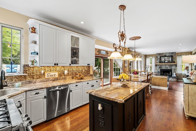 626 Windcrest Ct, Brick, NJ 08724 - kitchen with stainless steel appliances, a fireplace, white cabinets, hanging light fixtures, and light stone counters