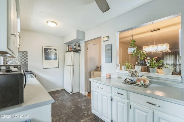 321 Spring St Unit 8, Red Bank, NJ 07701 - kitchen with freestanding refrigerator, light countertops, white cabinetry, decorative backsplash, and hanging light fixtures