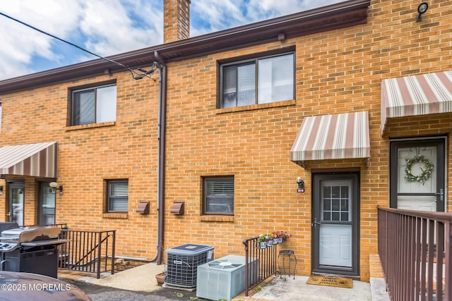 321 Spring St Unit 8, Red Bank, NJ 07701 - back of house with central air condition unit and brick siding