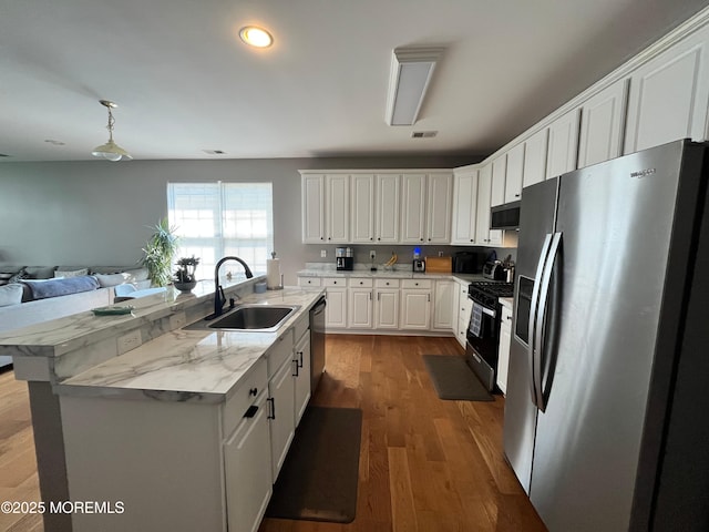 16 Woodstock Ct, Jackson, NJ 08527 - kitchen featuring stainless steel appliances, white cabinetry, open floor plan, wood finished floors, and an island with sink