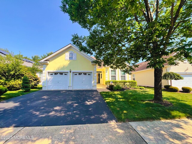 16 Woodstock Ct, Jackson, NJ 08527 - traditional-style house with asphalt driveway, a front lawn, stucco siding, and an attached garage