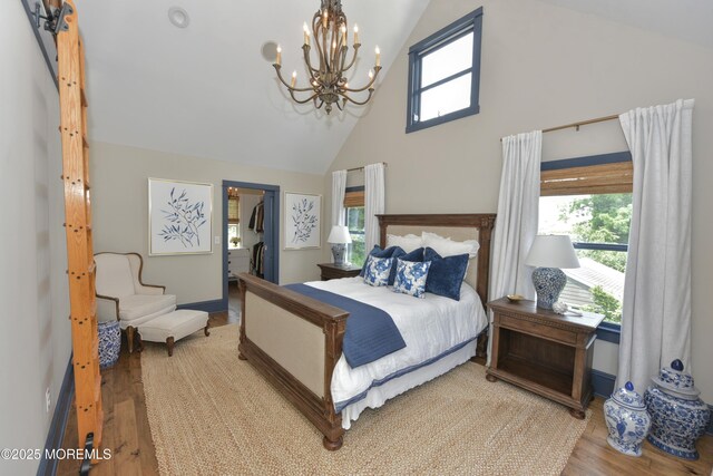 51 Clay St, Fair Haven, NJ 07704 - bedroom featuring high vaulted ceiling, a chandelier, wood finished floors, multiple windows, and a spacious closet