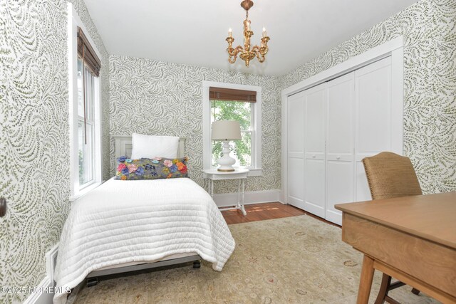 51 Clay St, Fair Haven, NJ 07704 - bedroom featuring wallpapered walls, wood finished floors, a chandelier, and a closet