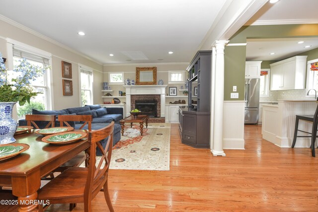 51 Clay St, Fair Haven, NJ 07704 - dining space with ornamental molding, light wood-type flooring, a fireplace, ornate columns, and recessed lighting