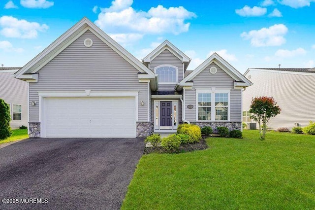 11 Starry Ln, Barnegat, NJ 08005 - view of front of house with stone siding, asphalt driveway, a front lawn, and a garage