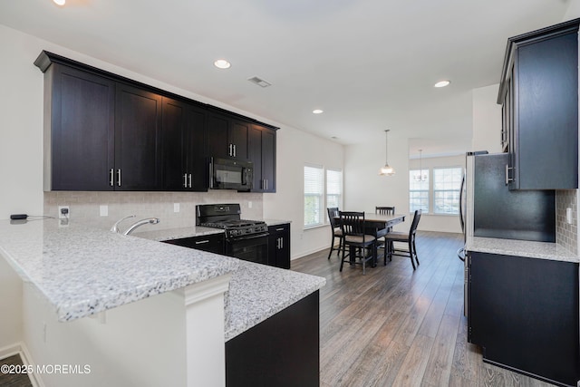 11 Starry Ln, Barnegat, NJ 08005 - kitchen with black appliances, a peninsula, hanging light fixtures, backsplash, and light wood finished floors
