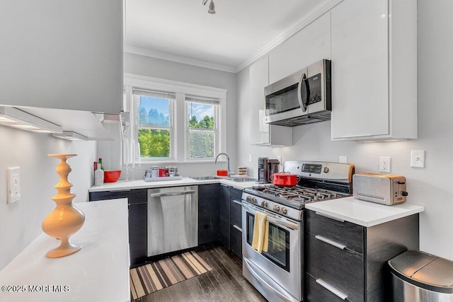 708 7th Ave, Asbury Park, NJ 07712 - kitchen featuring stainless steel appliances, a sink, light countertops, ornamental molding, and white cabinetry