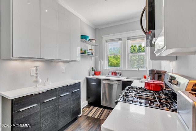 708 7th Ave, Asbury Park, NJ 07712 - kitchen with appliances with stainless steel finishes, a sink, ornamental molding, light countertops, and dark wood-style floors