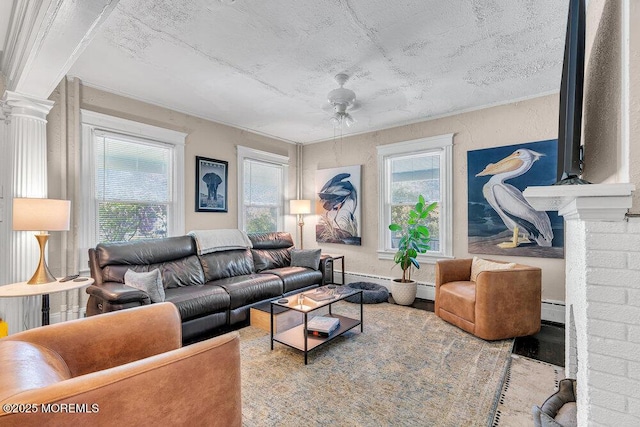 708 7th Ave, Asbury Park, NJ 07712 - living area featuring baseboard heating, ceiling fan, ornate columns, and wood finished floors
