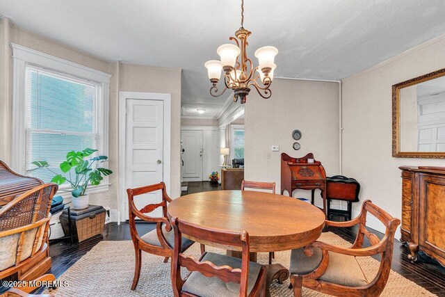 708 7th Ave, Asbury Park, NJ 07712 - dining area featuring wood finished floors, a chandelier, and crown molding