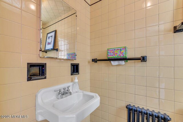 708 7th Ave, Asbury Park, NJ 07712 - bathroom featuring radiator, a sink, and tile walls