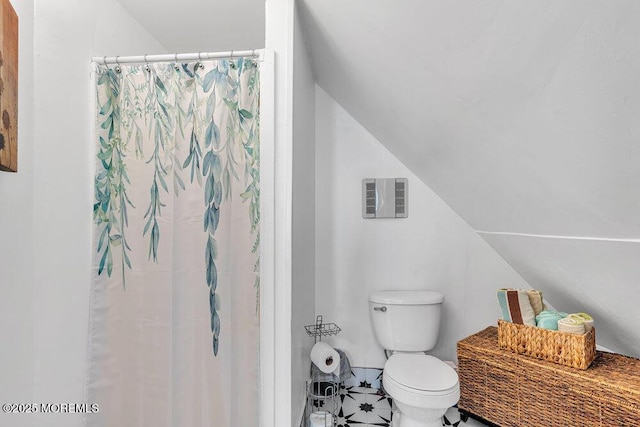 708 7th Ave, Asbury Park, NJ 07712 - full bathroom featuring toilet, lofted ceiling, tile patterned flooring, and a shower with shower curtain