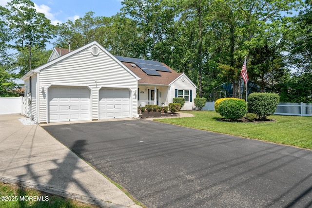 470 Nautilus Dr, Manahawkin, NJ 08050 - view of front of property featuring driveway, a garage, roof mounted solar panels, a shingled roof, and covered porch