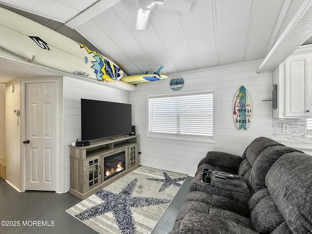 709 Union Ave Unit 5, Brielle, NJ 08730 - living room featuring lofted ceiling, a glass covered fireplace, and wood walls