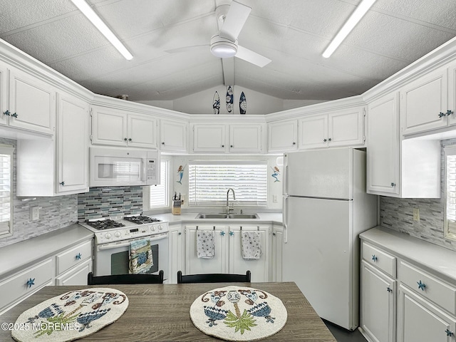 709 Union Ave Unit 5, Brielle, NJ 08730 - kitchen featuring white appliances, white cabinets, decorative backsplash, and vaulted ceiling