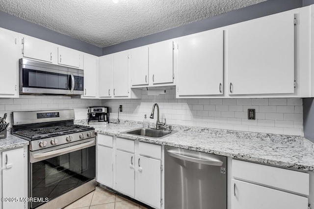 305 Daisy Ct, Jackson, NJ 08527 - kitchen featuring appliances with stainless steel finishes, a sink, white cabinets, decorative backsplash, and a textured ceiling