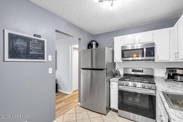 305 Daisy Ct, Jackson, NJ 08527 - kitchen featuring stainless steel appliances, light countertops, white cabinets, a textured ceiling, and tasteful backsplash