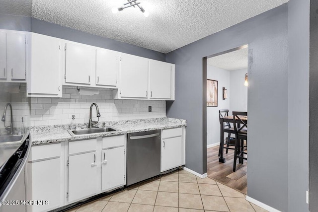 305 Daisy Ct, Jackson, NJ 08527 - kitchen featuring stainless steel dishwasher, a sink, a textured ceiling, backsplash, and white cabinetry