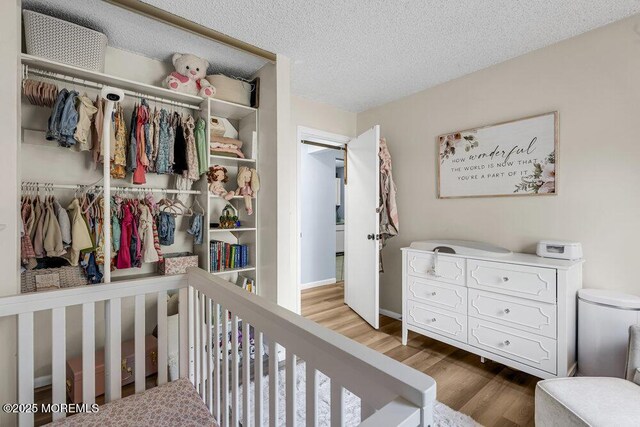 305 Daisy Ct, Jackson, NJ 08527 - bedroom featuring a closet, wood finished floors, and a textured ceiling