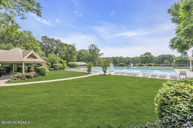 305 Daisy Ct, Jackson, NJ 08527 - view of green lawn featuring a community pool and view of wooded area