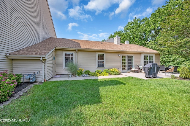 6 Claridge Ct # 5, Freehold, NJ 07728 - rear view of property featuring a patio, a lawn, a chimney, and roof with shingles
