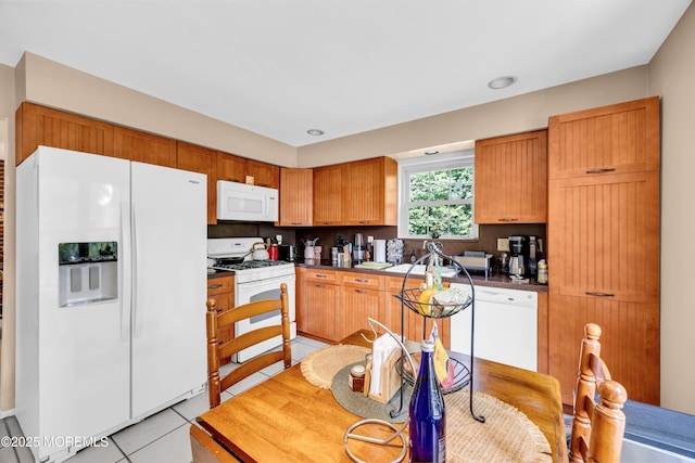 6 Claridge Ct # 5, Freehold, NJ 07728 - kitchen with white appliances, light tile patterned floors, tasteful backsplash, and dark countertops