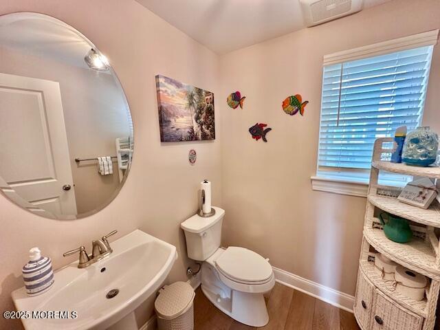 64 Sheridan Ave Unit A, Seaside Heights, NJ 08751 - half bathroom featuring a sink, wood finished floors, toilet, and baseboards
