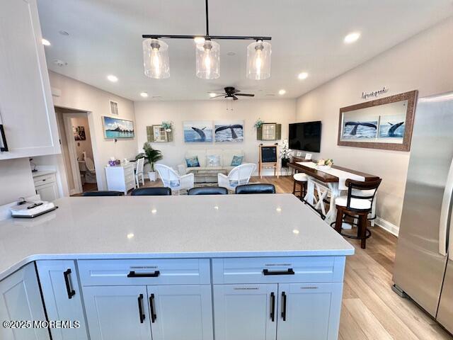 64 Sheridan Ave Unit A, Seaside Heights, NJ 08751 - kitchen featuring freestanding refrigerator, ceiling fan, light countertops, light wood-type flooring, and pendant lighting