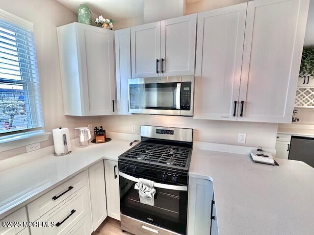 64 Sheridan Ave Unit A, Seaside Heights, NJ 08751 - kitchen featuring stainless steel appliances, light countertops, and white cabinetry