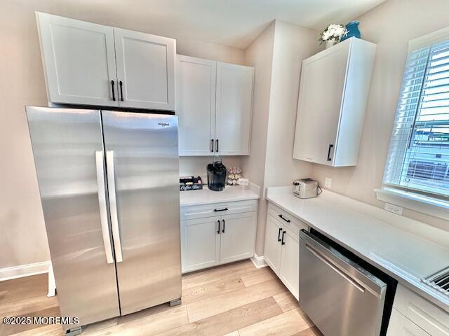 64 Sheridan Ave Unit A, Seaside Heights, NJ 08751 - kitchen featuring stainless steel appliances, light wood-style floors, light countertops, white cabinetry, and baseboards